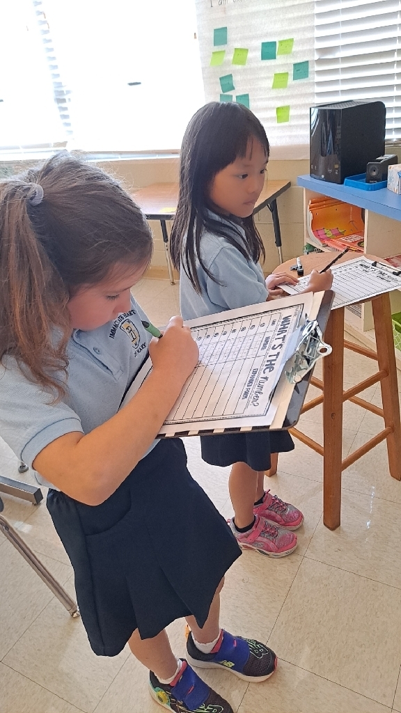two 2nd graders work on their math problems 