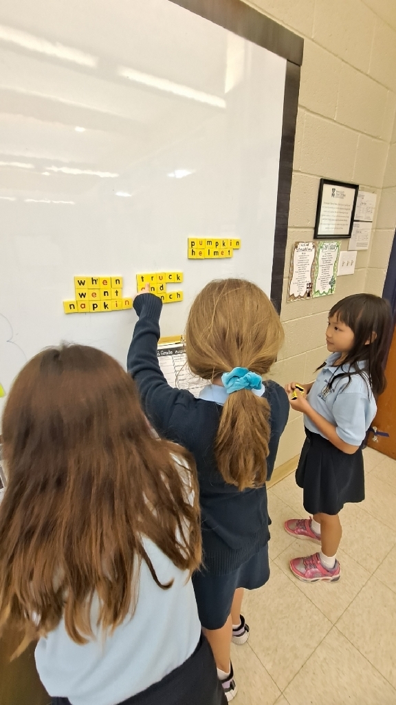 Students building spelling words with magnets