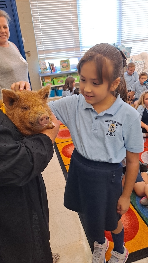 2nd graders petting the piglet