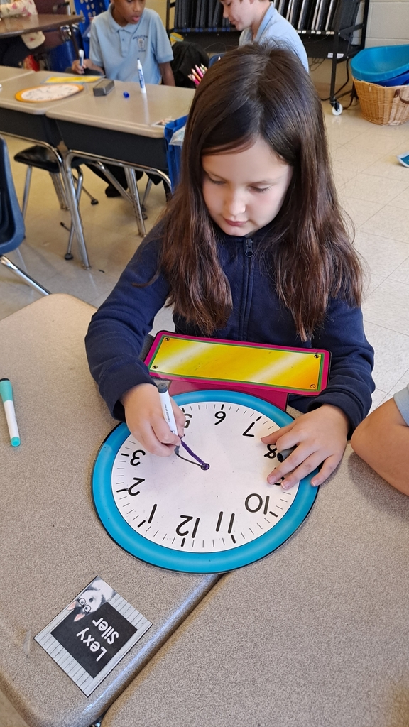 2nd grader working on making time on a clock