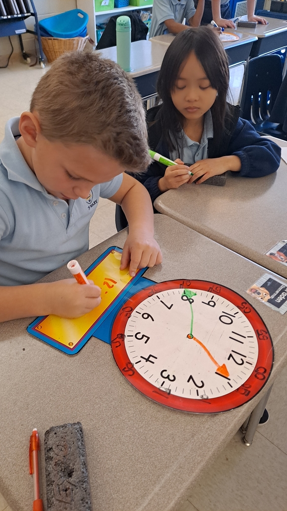 2nd grader working on making time on a clock 