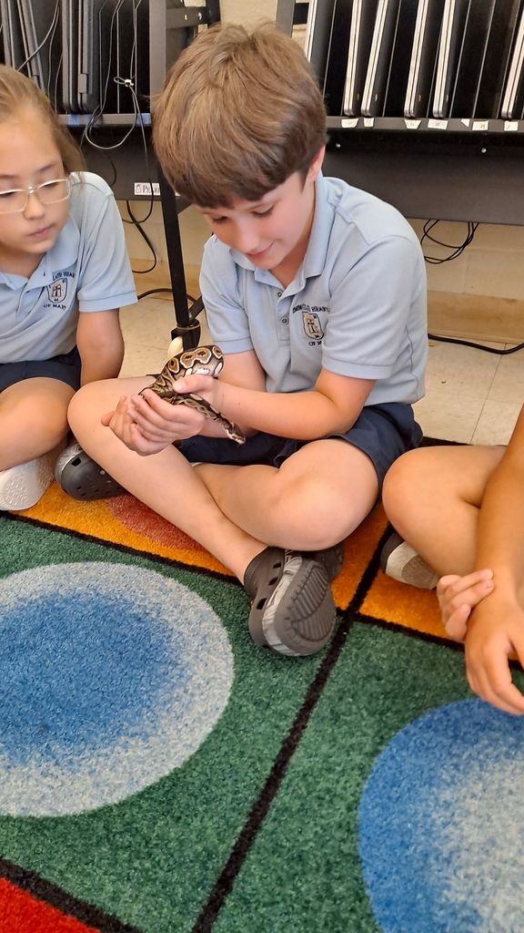 2nd graders holding a snake